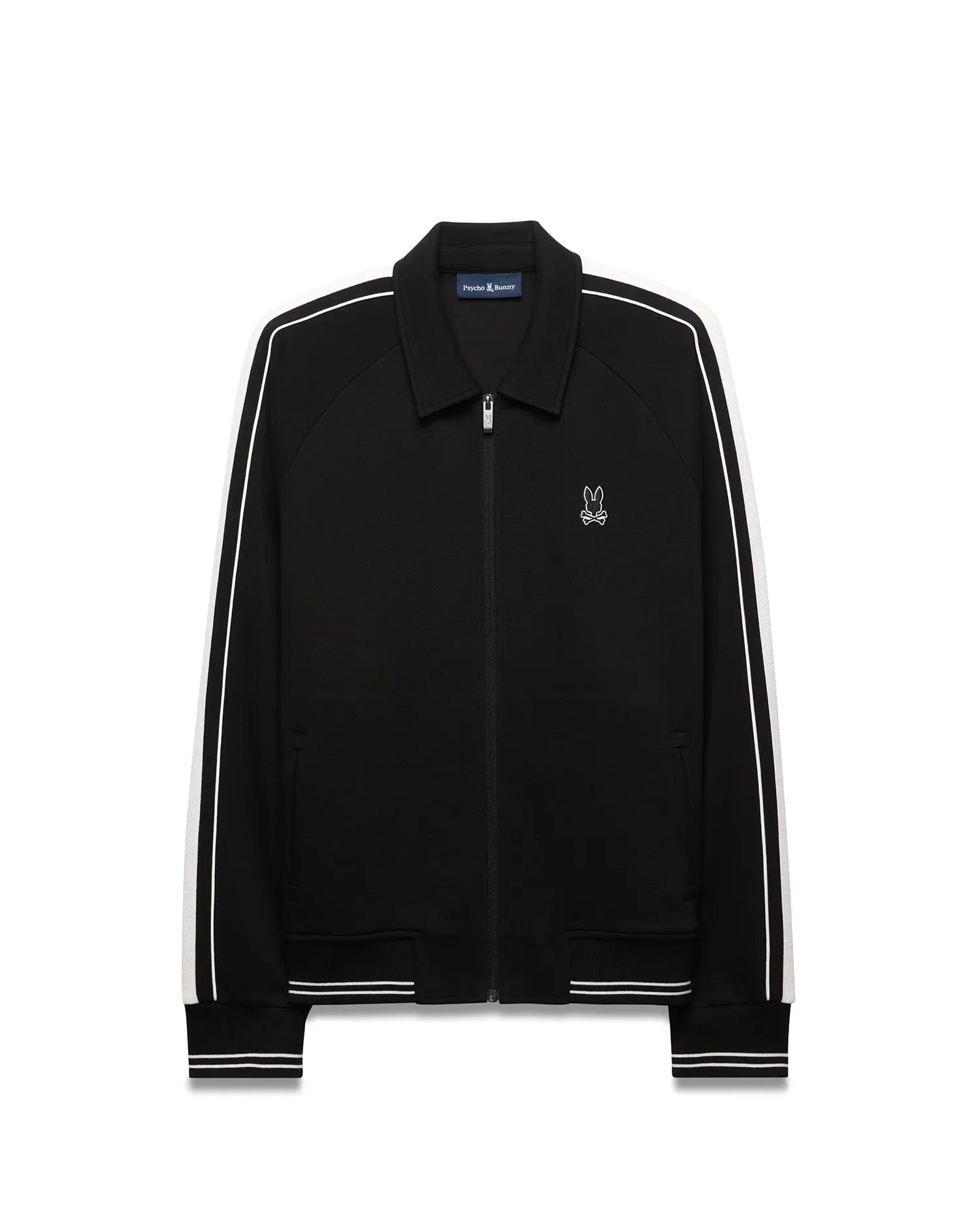 Mens Ceano Track Jacket, black smooth knit with a classic fit, featuring white double stripes on raglan sleeves, ribbed collar, cuffs, and hem, and a small embroidered white Psycho Bunny skull logo on the left chest.