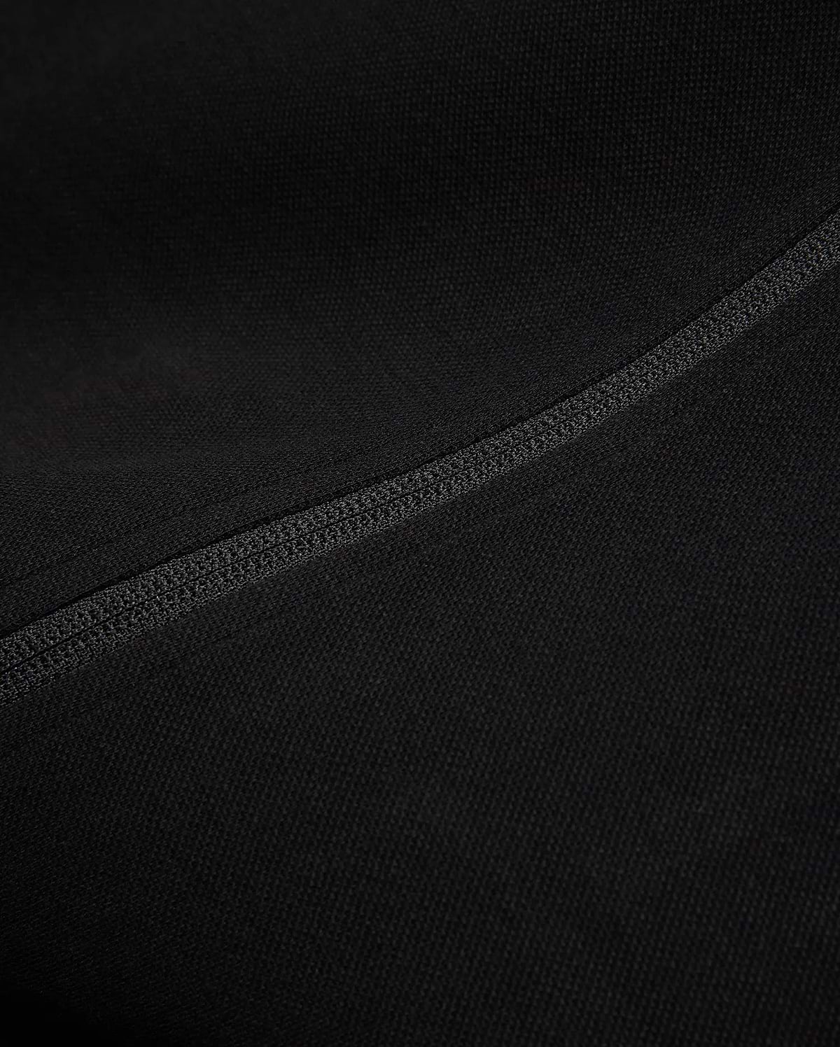 Black Mens Ceano Track Jacket featuring a smooth, finely textured knit fabric, accented by a prominent, precisely stitched flatlock seam running diagonally across the garment.