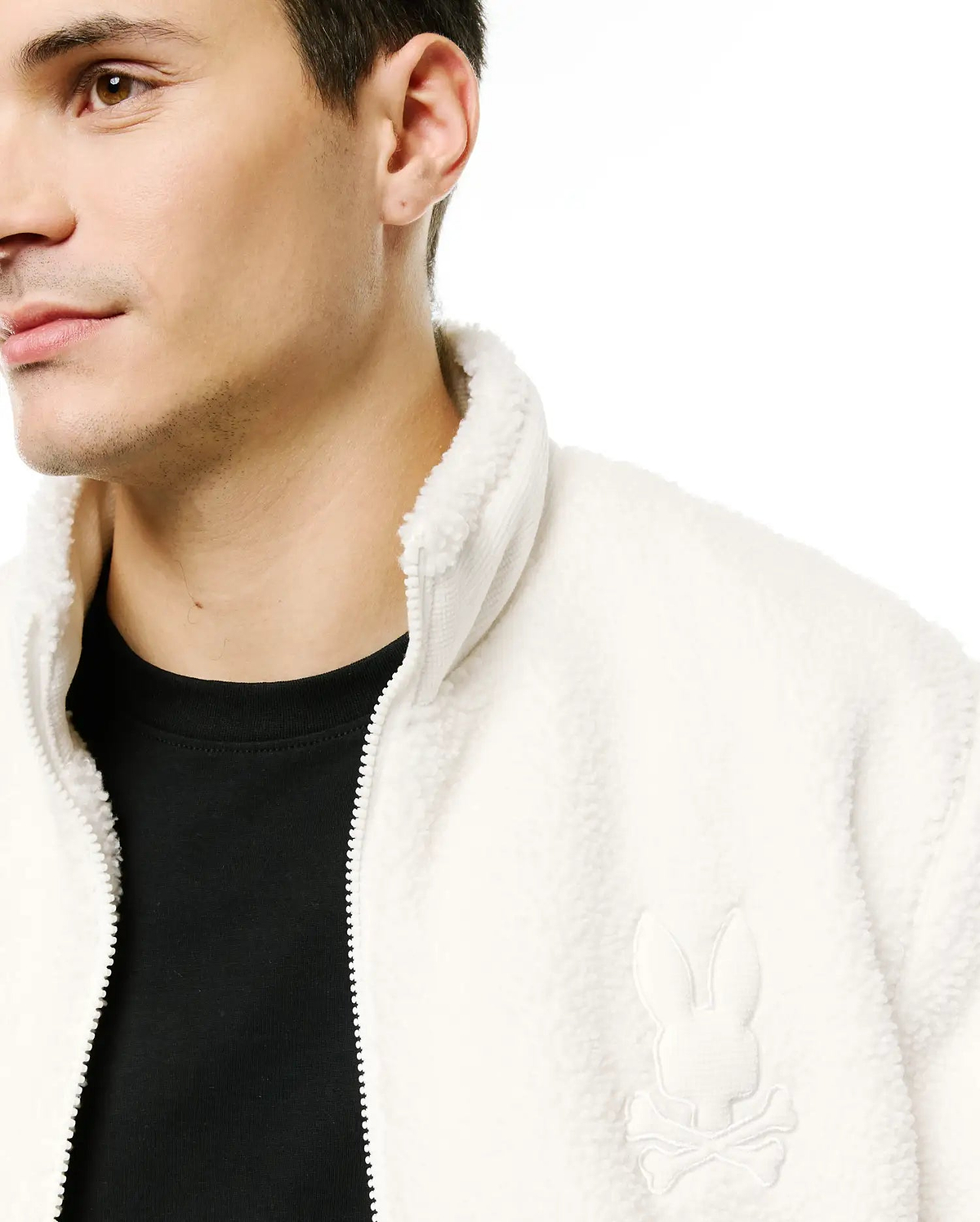 Men's Rowley Sherpa Zip Jacket in cream, featuring a cozy sherpa fleece texture, full zip closure, stand collar, and a small embroidered Psycho Bunny skull logo on the left chest. (2)