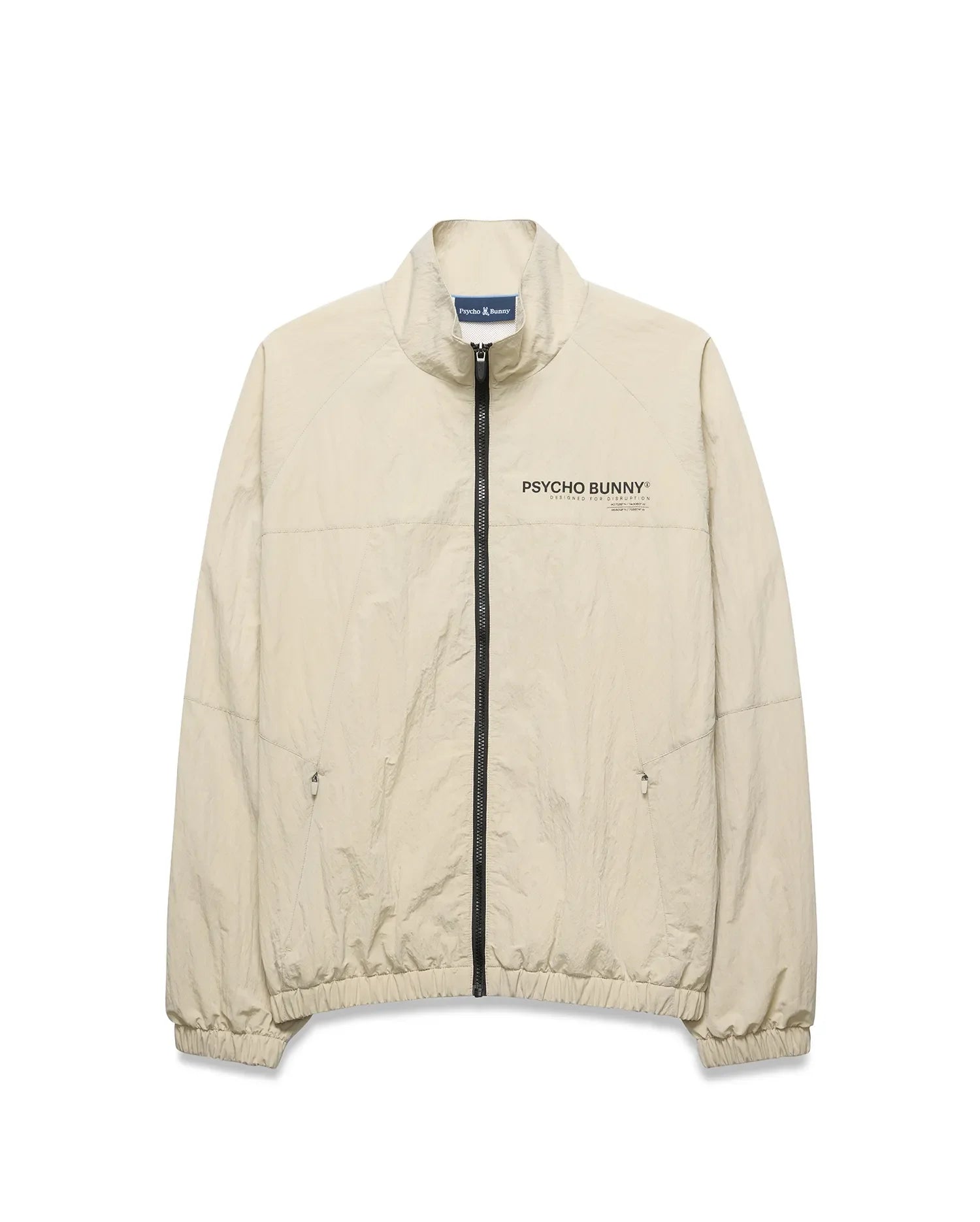 Light beige Mens Alder Nylon Jacket, a classic fit crinkled nylon jacket with full black zip, stand collar, zippered side pockets, elastic cuffs/hem, and a black Psycho Bunny chest logo. (6)