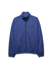 Mens Alder Nylon Jacket, a royal blue full-zip jacket with a crinkled texture, features a stand collar, elastic cuffs/hem, zippered pockets, and a large black PSYCHO BUNNY® DESIGNED FOR DISRUPTION text logo on the chest. (5)