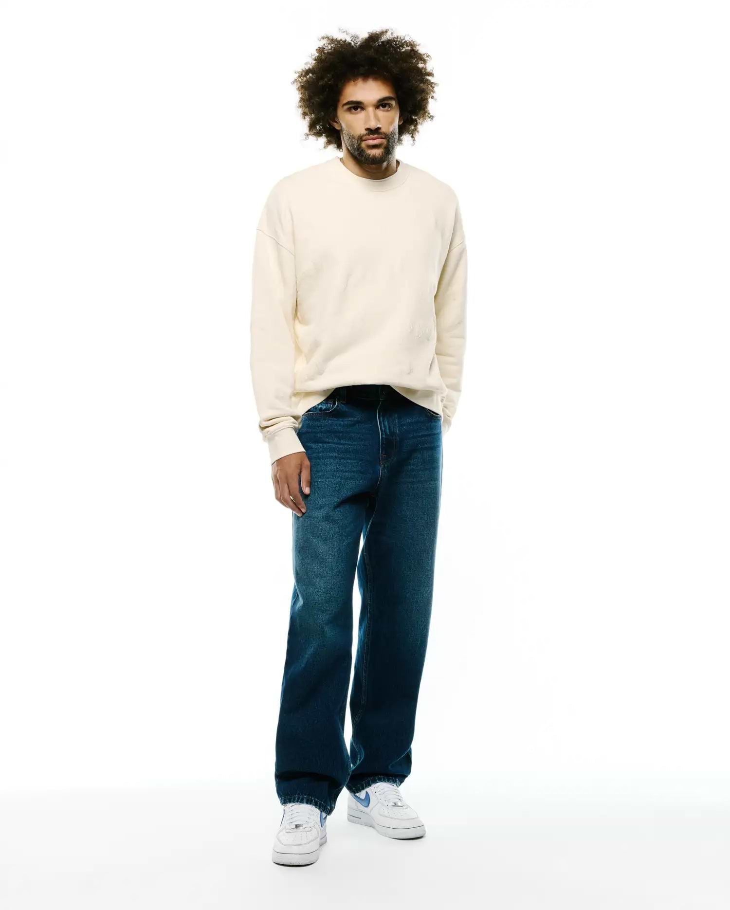 Mens Cedrick All Over Jacquard Crew in soft cream, a relaxed fit crewneck sweatshirt with a subtle all-over jacquard pattern and ribbed cuffs and hem, showcasing premium Psycho Bunny quality without a visible logo.