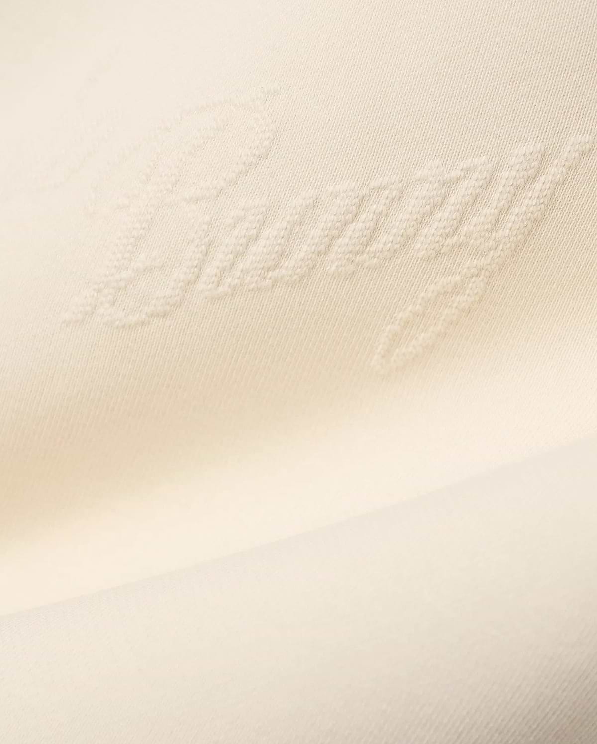 Mens Cedrick All Over Jacquard Crew in creamy off-white, featuring a subtle raised jacquard knit pattern of the word Bunny throughout the fabric.