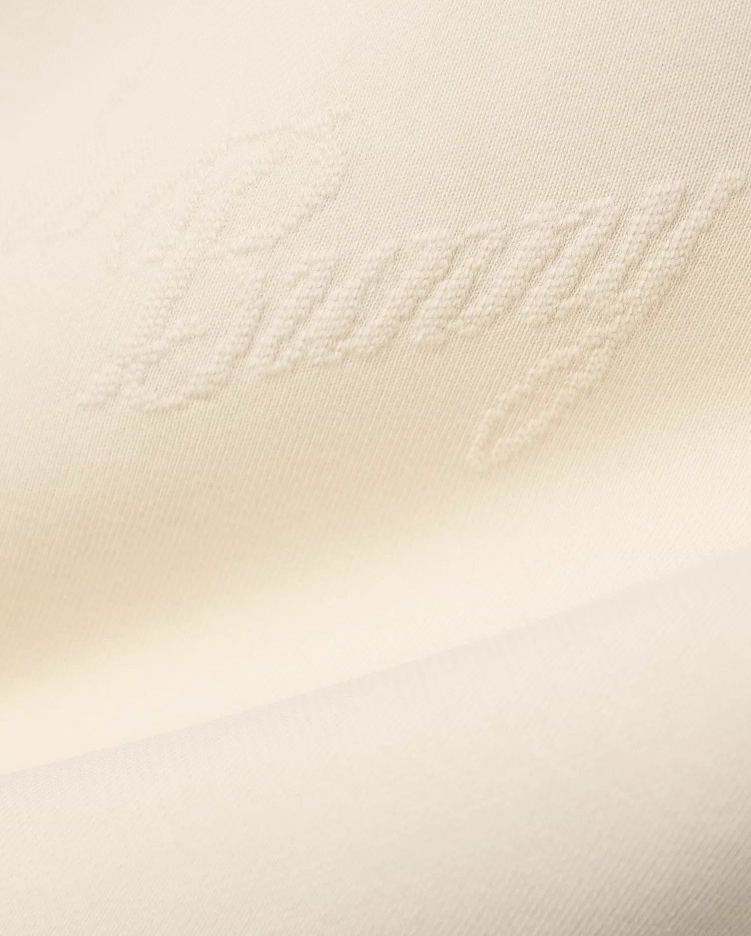 Mens Cedrick All Over Jacquard Crew in creamy off-white, featuring a subtle raised jacquard knit pattern of the word Bunny throughout the fabric.