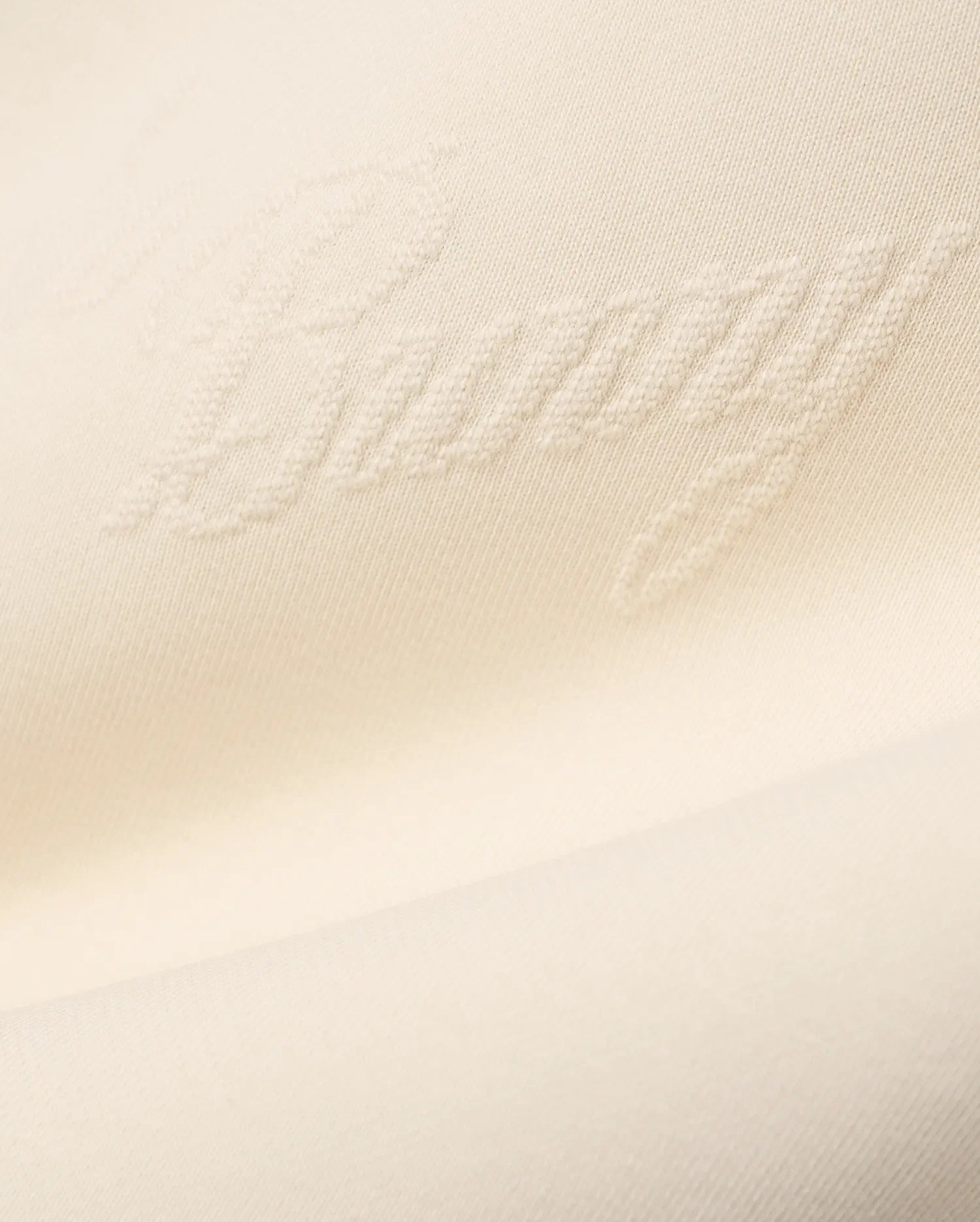 Mens Cedrick All Over Jacquard Crew in creamy off-white, featuring a subtle raised jacquard knit pattern of the word Bunny throughout the fabric.