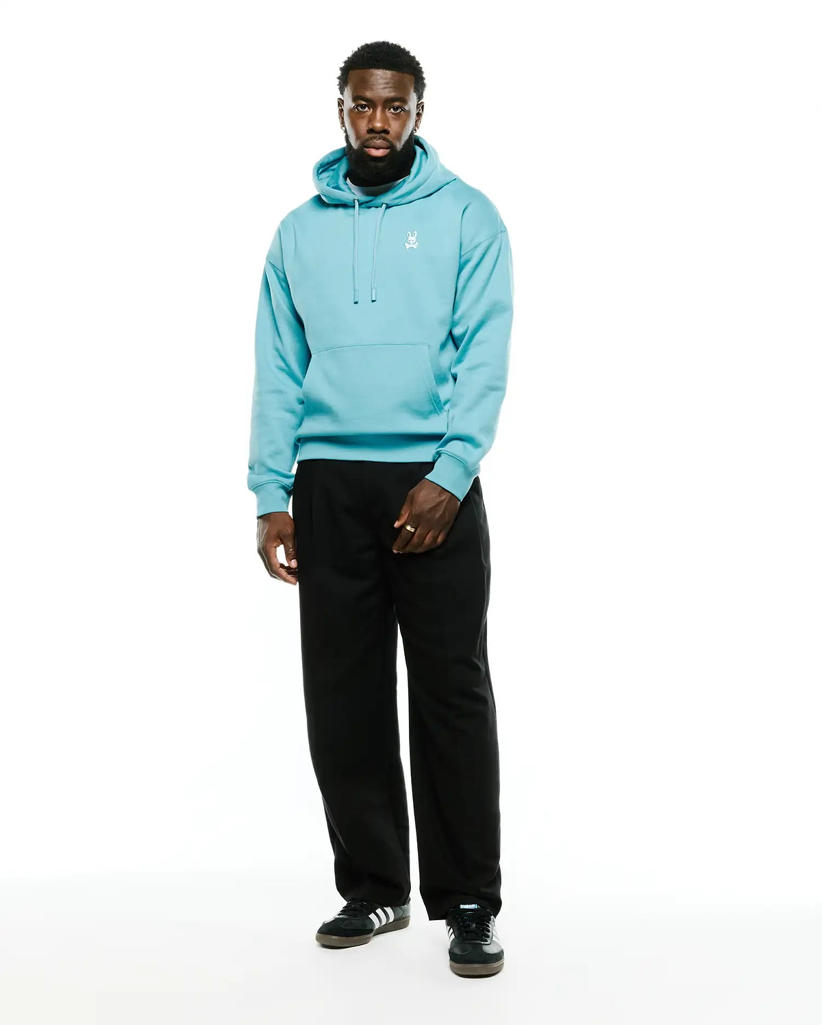 Men's Terrence Fleece Hoodie in aqua blue, featuring a relaxed fit, soft fleece texture, drawstring hood, kangaroo pocket, and a small white embroidered Psycho Bunny skull logo on the left chest. (4)