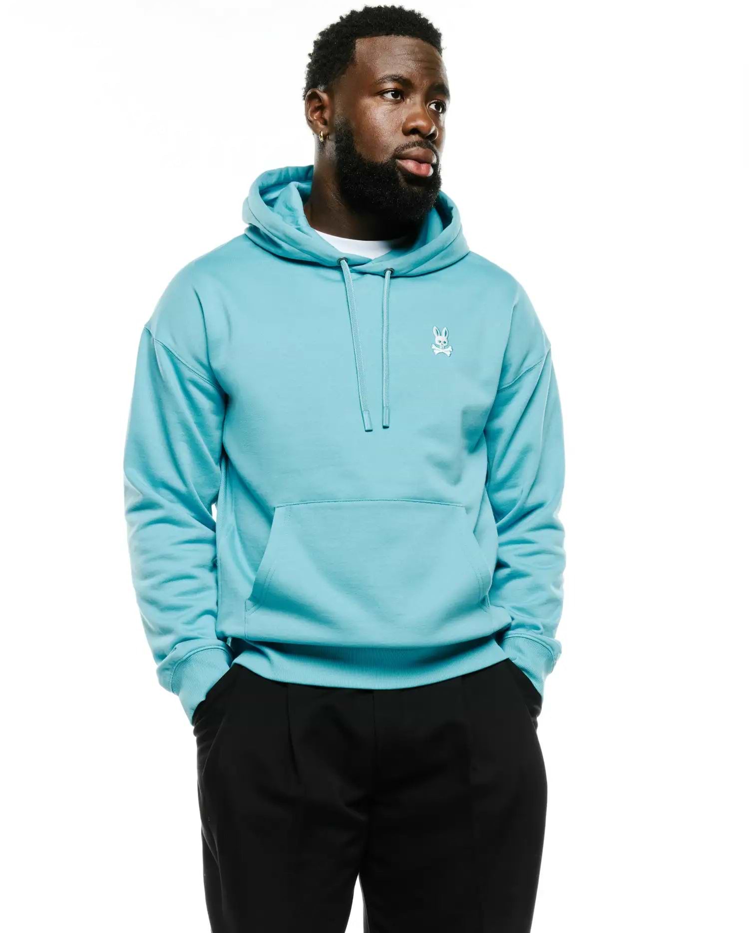 Men's Terrence Fleece Hoodie, a relaxed fit aqua blue hoodie with smooth fleece, featuring a small white embroidered Psycho Bunny skull logo on the left chest and a front kangaroo pocket. (1)