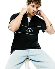Mens Stevie French Terry Ss 1/4 Zip in black, featuring a classic fit, two white horizontal stripes, and a prominent embroidered white Psycho Bunny skull logo with text on the chest.