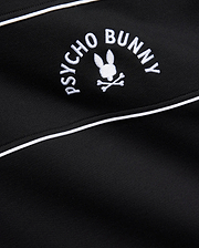 Mens Stevie French Terry Ss 1/4 Zip in black french terry, featuring a prominent white embroidered Psycho Bunny skull logo with curved text and white piping detail.