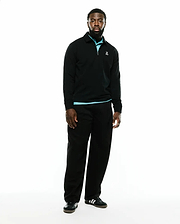 Men's Samson Quarter-Zip Sweater, a classic fit black smooth knit quarter-zip with a collared neckline, light blue accent at the collar and hem, and a small embroidered white Psycho Bunny skull logo on the left chest. (1)