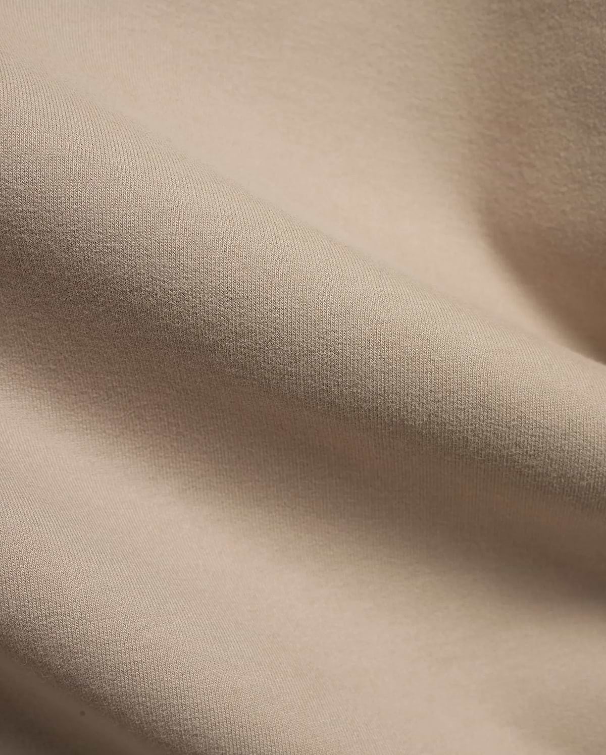 MEN'S SAMSON QUARTER-ZIP SWEATER in a premium, soft beige knit fabric, featuring a subtle vertical texture and gentle folds, indicating a comfortable, refined style. (6)