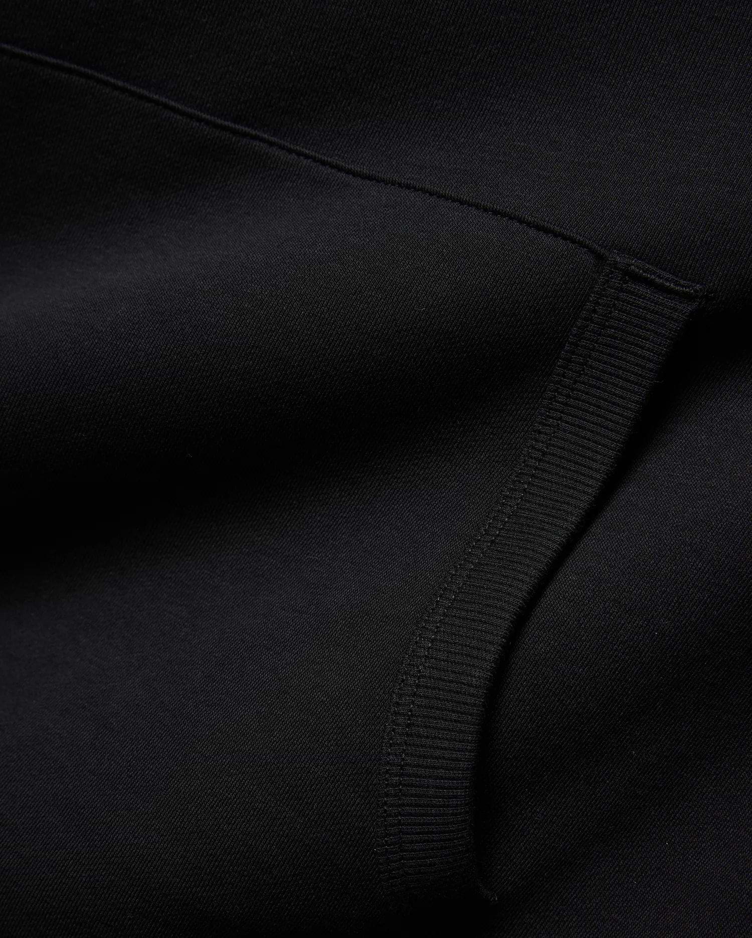 Mens Nathaniel Relaxed Chest Hoodie in deep black, crafted from a soft knit fabric with a subtle diagonal texture and a prominent ribbed cuff detail. (6)