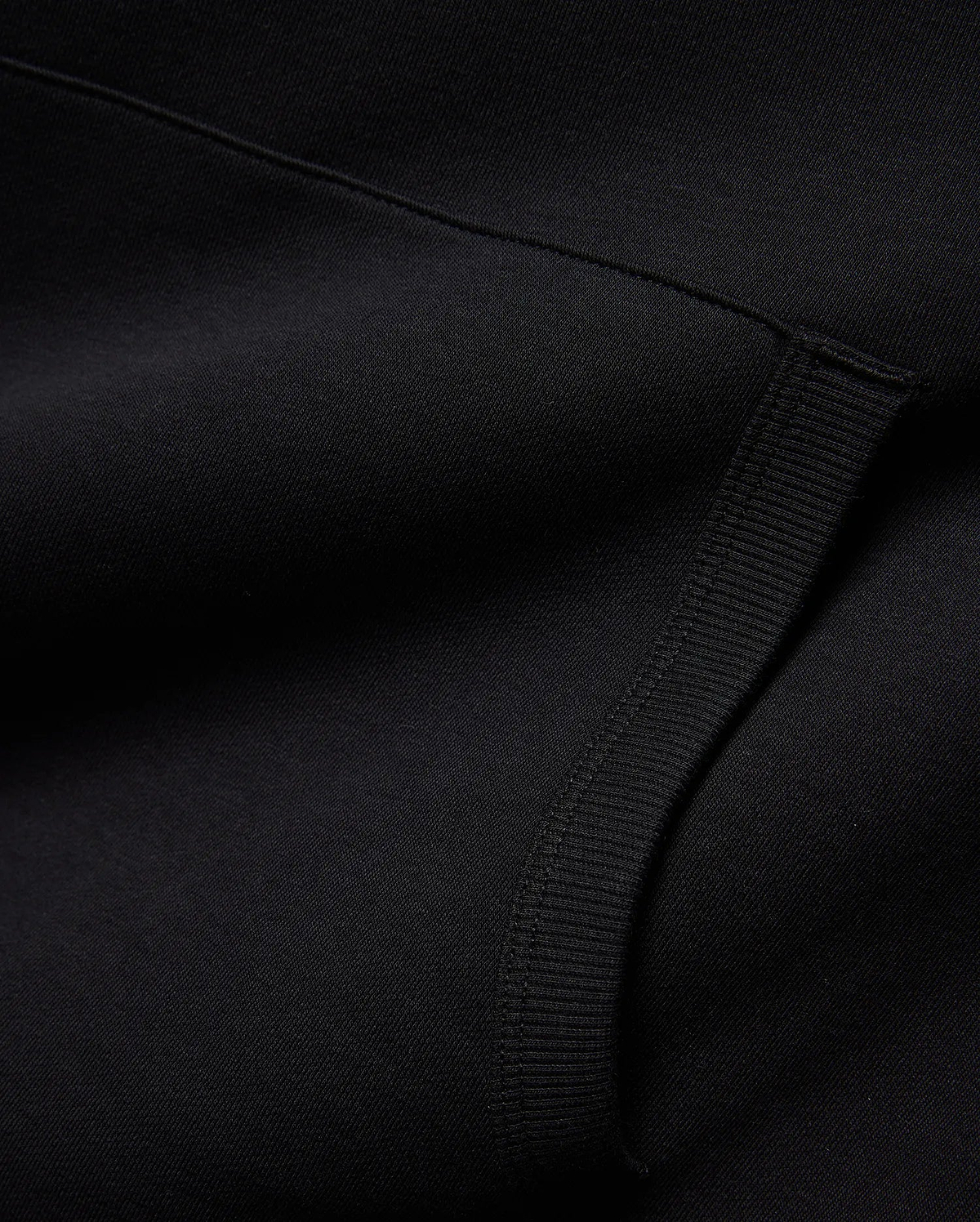 Mens Nathaniel Relaxed Chest Hoodie in deep black, crafted from a soft knit fabric with a subtle diagonal texture and a prominent ribbed cuff detail. (6)