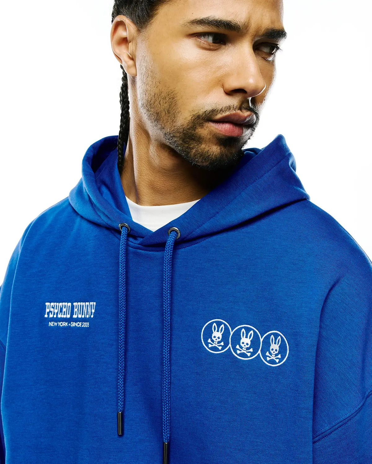 Mens Nathaniel Relaxed Chest Hoodie in royal blue French terry, featuring a relaxed fit. White embroidered Psycho Bunny text with New York Since 2005 on the left chest, and three small white embroidered bunny skull logos on the right chest. (3)