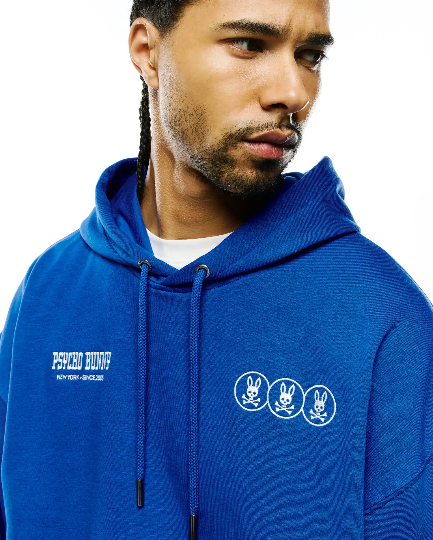 Mens Nathaniel Relaxed Chest Hoodie in royal blue French terry, featuring a relaxed fit. White embroidered Psycho Bunny text with New York Since 2005 on the left chest, and three small white embroidered bunny skull logos on the right chest. (3)