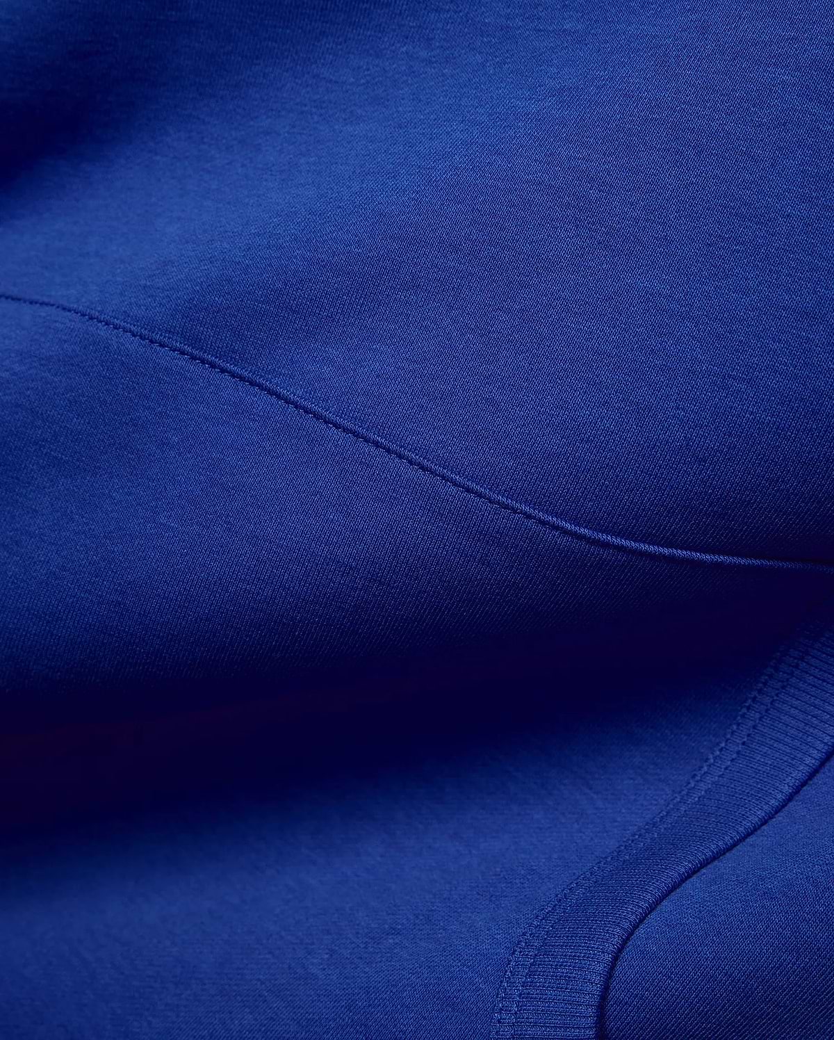 Vibrant royal blue Mens Nathaniel Relaxed Chest Hoodie, crafted from soft jersey fabric with visible seam stitching and a ribbed hem detail, embodying refined streetwear. (6)
