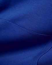 Vibrant royal blue Mens Nathaniel Relaxed Chest Hoodie, crafted from soft jersey fabric with visible seam stitching and a ribbed hem detail, embodying refined streetwear. (6)