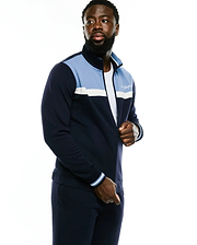 Men's Jacques Pique Track Jacket in navy with light blue and white color block panels, full zip, ribbed cuffs, and an embroidered Psycho Bunny script logo on the left chest. (2)