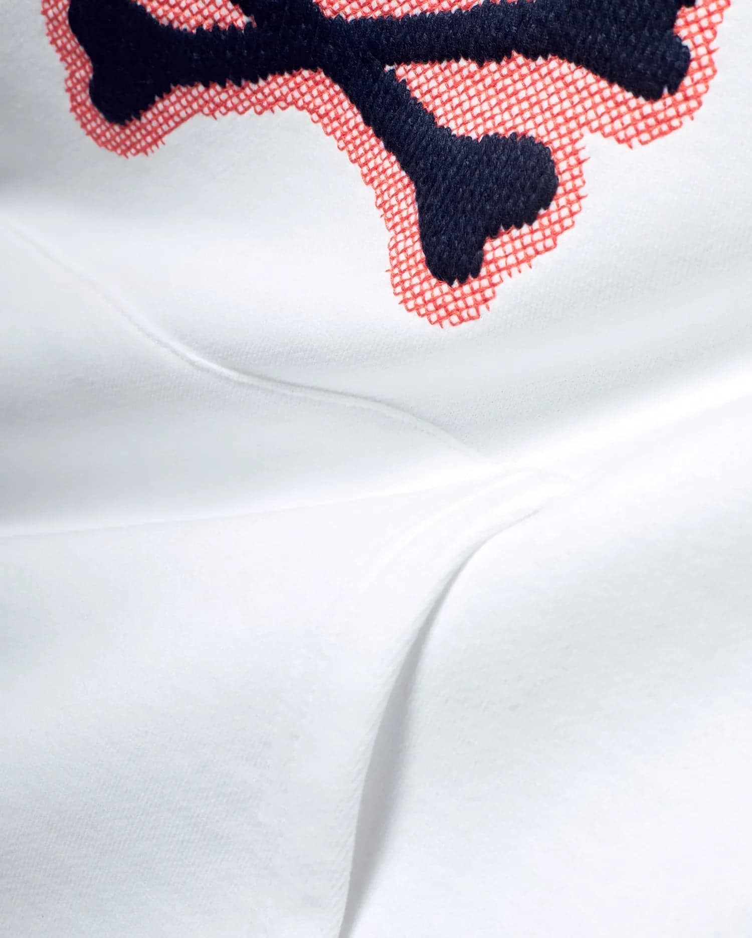 White Men's Samson Cotton Hoodie featuring a large, detailed embroidered Psycho Bunny skull logo with navy blue outline and red crosshatch fill on soft cotton jersey fabric. (6)