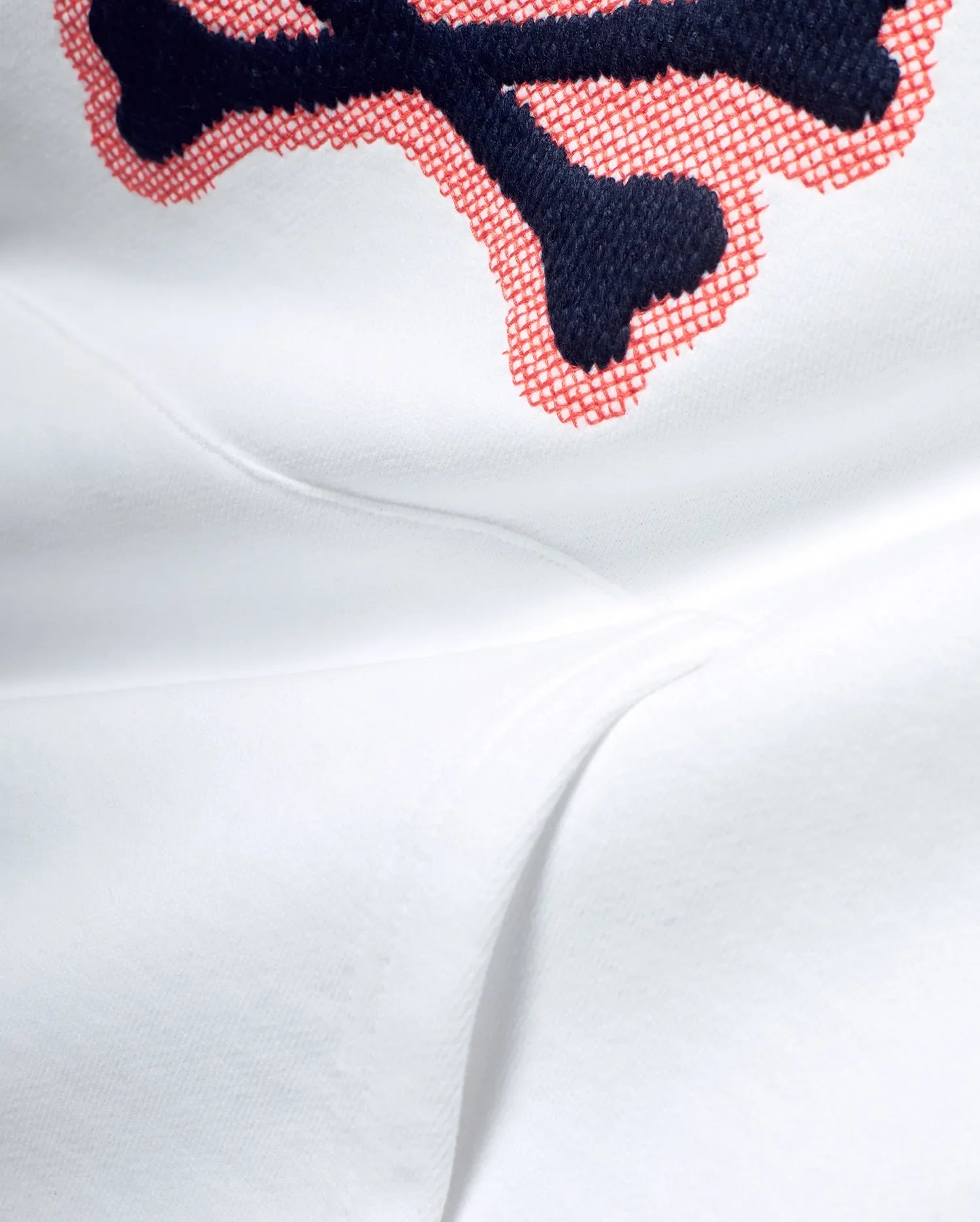 White Men's Samson Cotton Hoodie featuring a large, detailed embroidered Psycho Bunny skull logo with navy blue outline and red crosshatch fill on soft cotton jersey fabric. (6)