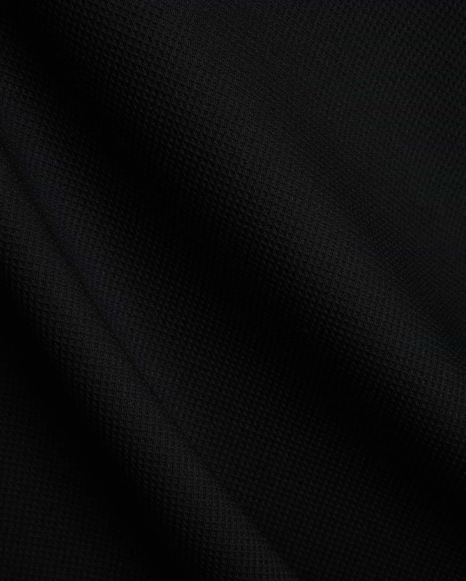 Mens Tomas Waffle Hoodie, a luxurious black waffle knit fabric, showcasing the premium texture and quality expected from Psycho Bunny refined streetwear.