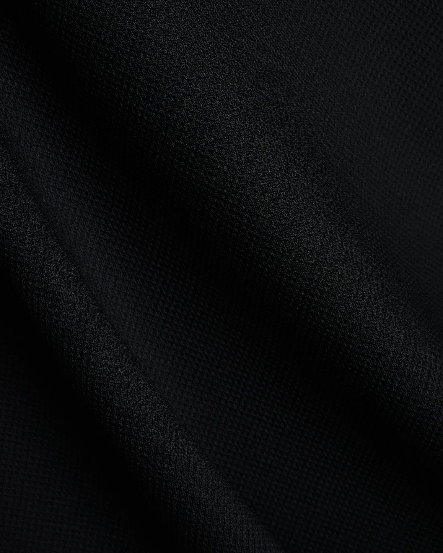 Mens Tomas Waffle Hoodie, a luxurious black waffle knit fabric, showcasing the premium texture and quality expected from Psycho Bunny refined streetwear.