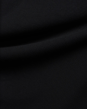 Premium black Tomas Waffle 1/4 Zip, showcasing its rich, deep black fabric with a prominent, textured waffle knit pattern and soft, flowing folds, embodying Psycho Bunny's refined streetwear.