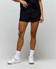 Womens Olivia Fleece Short, black relaxed-fit French terry shorts with a smooth texture and comfortable elastic waistband. No visible Psycho Bunny skull logo.