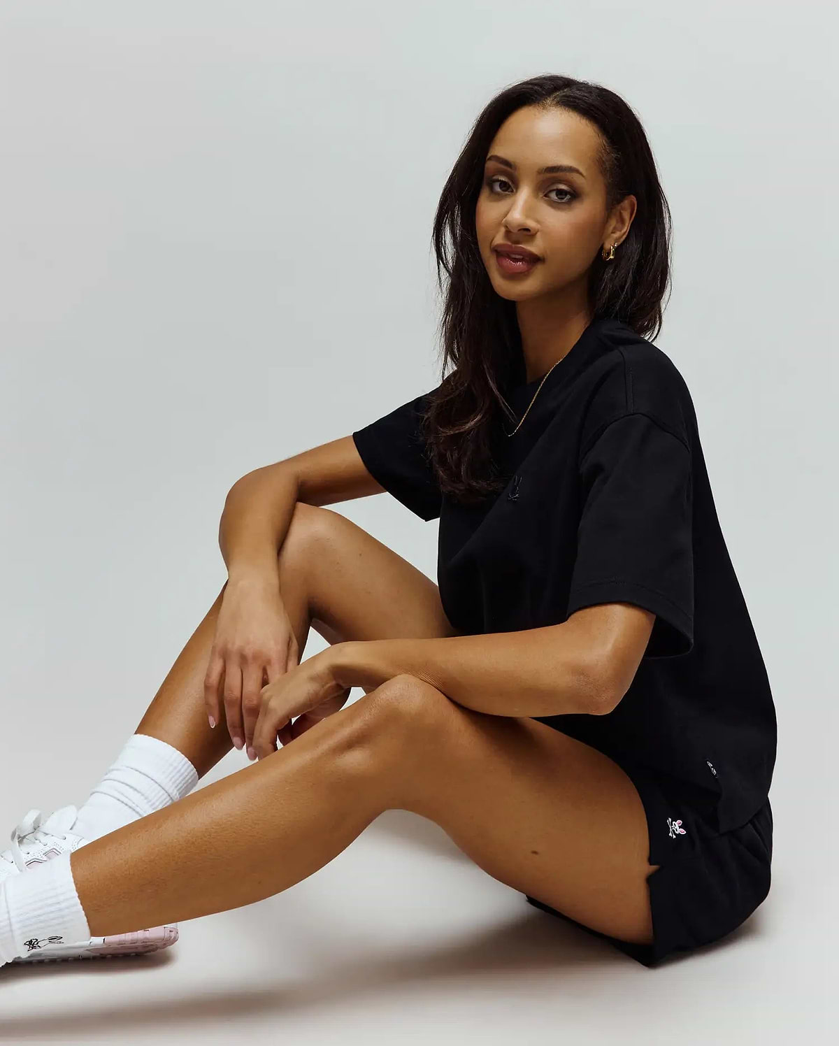 Black relaxed fit jersey t-shirt with a black embroidered bunny skull on the chest, and black Womens Olivia Fleece Short featuring a white/pink embroidered bunny skull on the left hem.