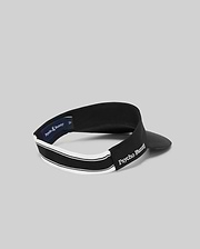 The WOMEN'S SPORT VISOR - WO1500001 by Psycho Bunny features a black design with white trim and "Psycho Bunny" embroidered in white on the side, shown against a plain gray background.
