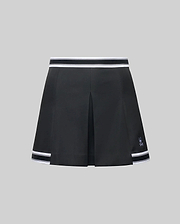 The WOMENS KNIT SKORT - WO1900001 by Psycho Bunny is a black pleated mini skort with white striped trim at the waistband and hem, plus a small white Psycho Bunny logo near the left hem, shown on a plain gray background. (6)