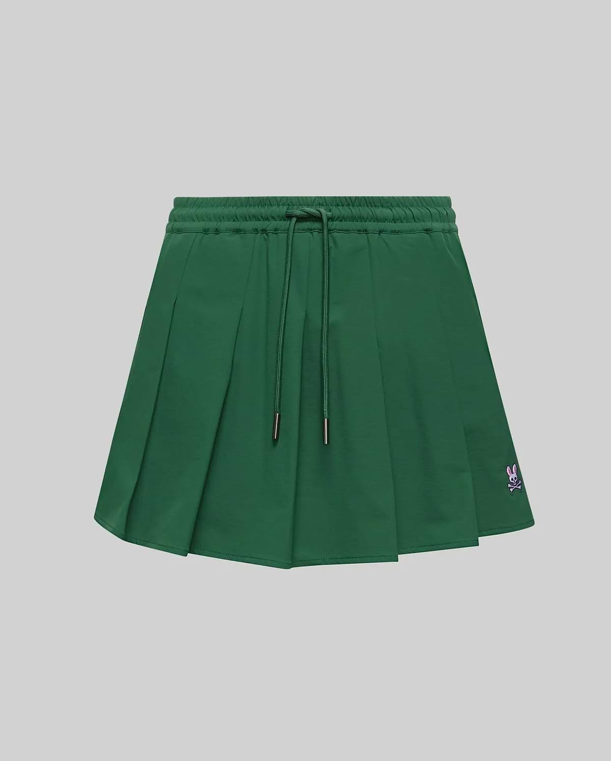 WOMEN'S CECILIA PLEATED SKORT in dark green, featuring an elastic drawstring waist, a relaxed A-line fit with crisp pleats, and a small embroidered pink Psycho Bunny skull logo on the lower right hem. (5)