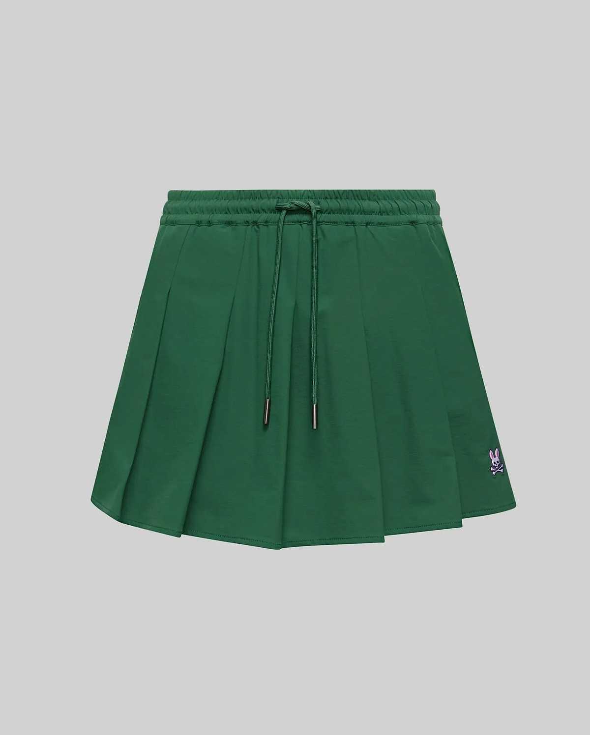 WOMEN'S CECILIA PLEATED SKORT in dark green, featuring an elastic drawstring waist, a relaxed A-line fit with crisp pleats, and a small embroidered pink Psycho Bunny skull logo on the lower right hem. (5)