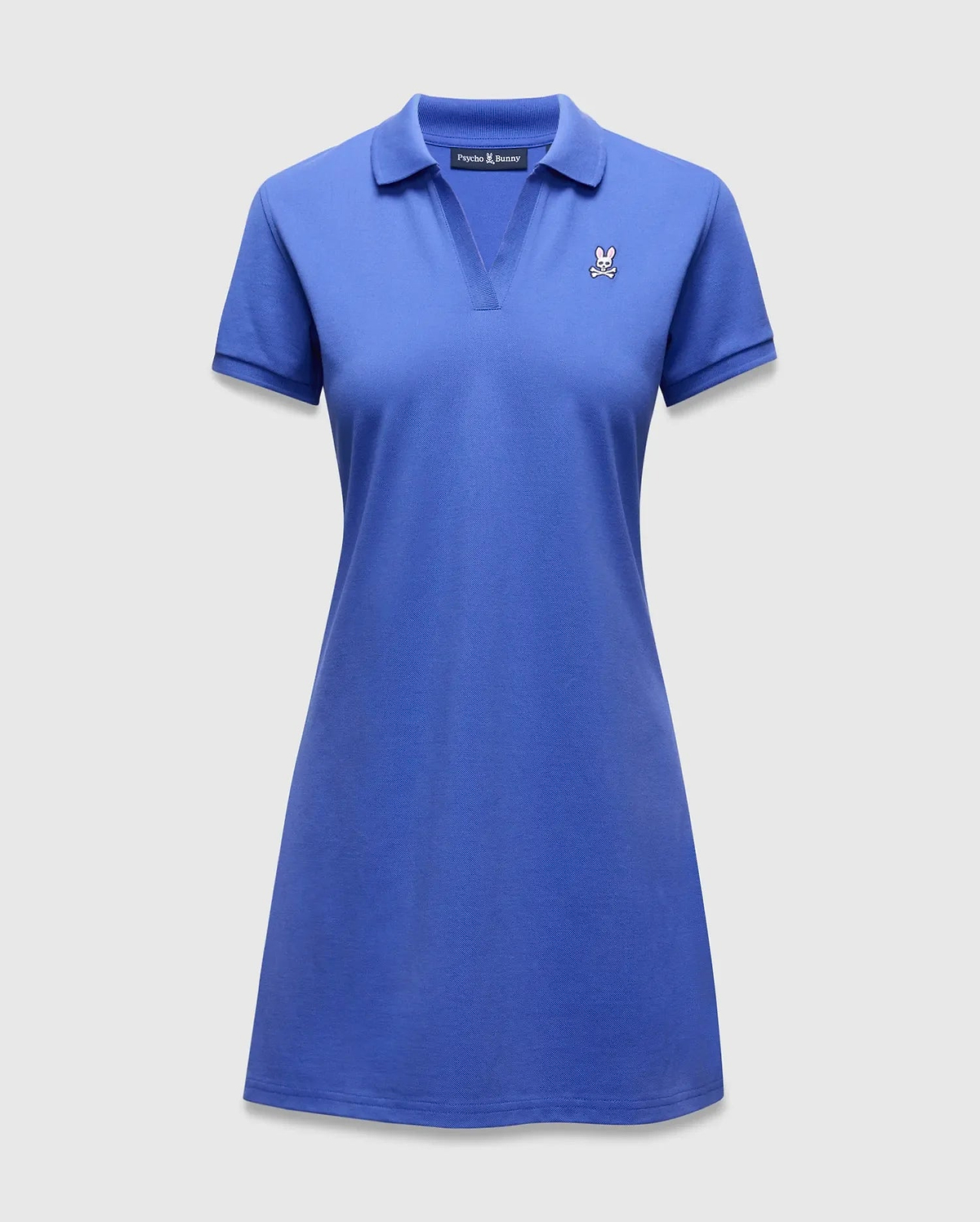 Women's Clara Pique Dress in vibrant royal blue, featuring a classic polo collar, V-neck, short sleeves, and a small embroidered Psycho Bunny skull logo on the left chest.