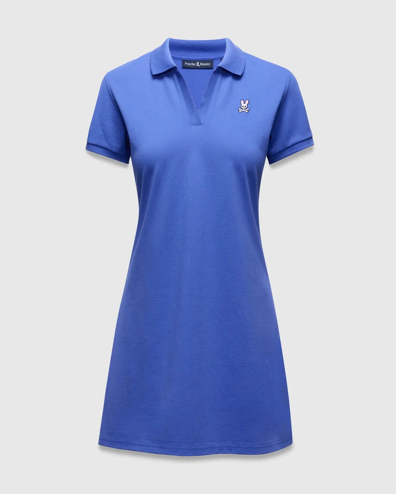 Women's Clara Pique Dress in vibrant royal blue, featuring a classic polo collar, V-neck, short sleeves, and a small embroidered Psycho Bunny skull logo on the left chest.