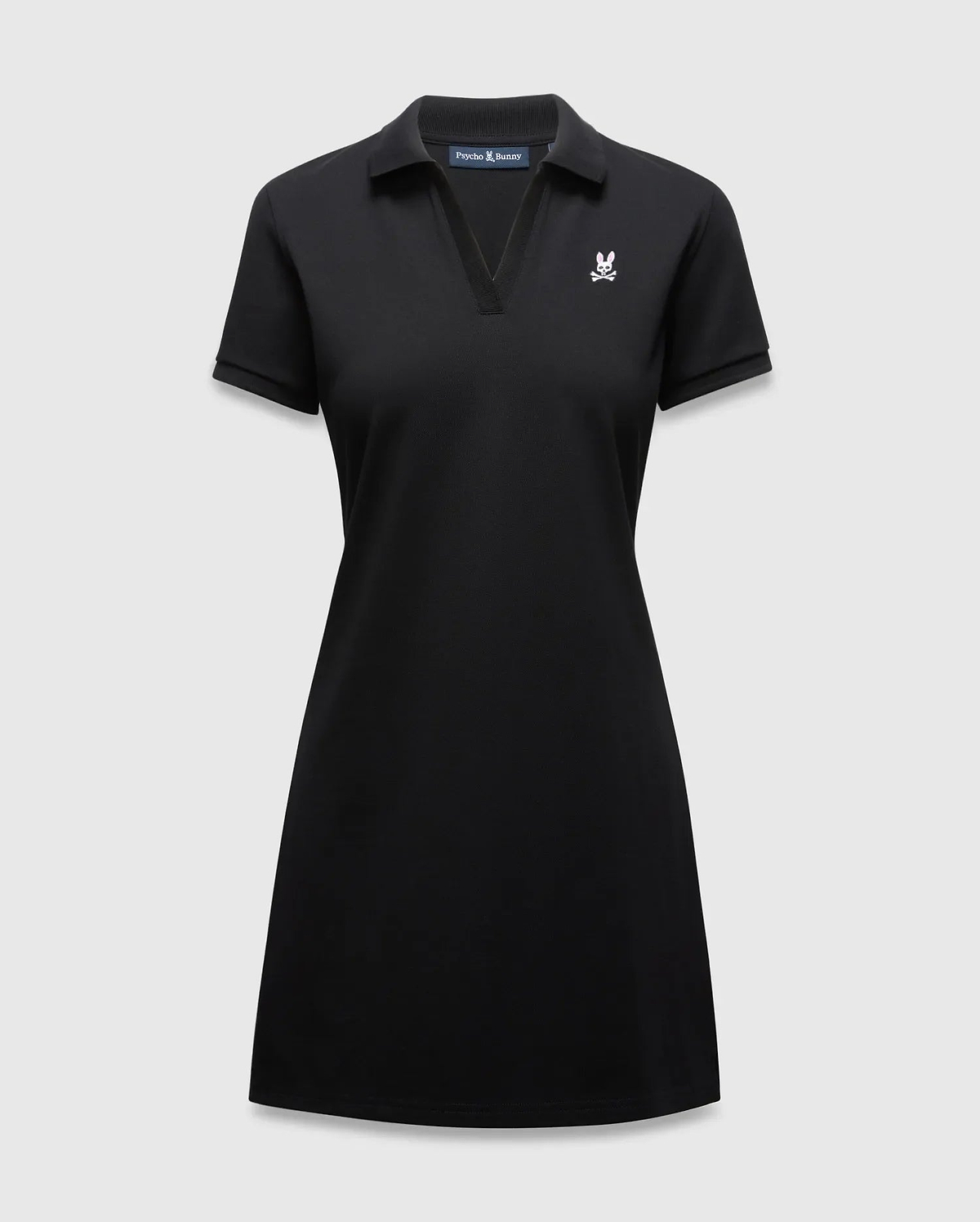 Women's Clara Pique Dress, a classic fit black pique polo dress with a V-neck, short sleeves, and a small white embroidered Psycho Bunny skull logo on the left chest. (5)