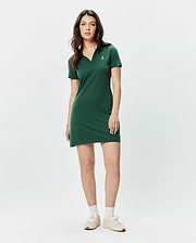 Women's Clara Pique Dress in dark green, featuring a classic fit, polo collar, V-neck, short sleeves, and a small embroidered white Psycho Bunny skull logo on the left chest. (4)