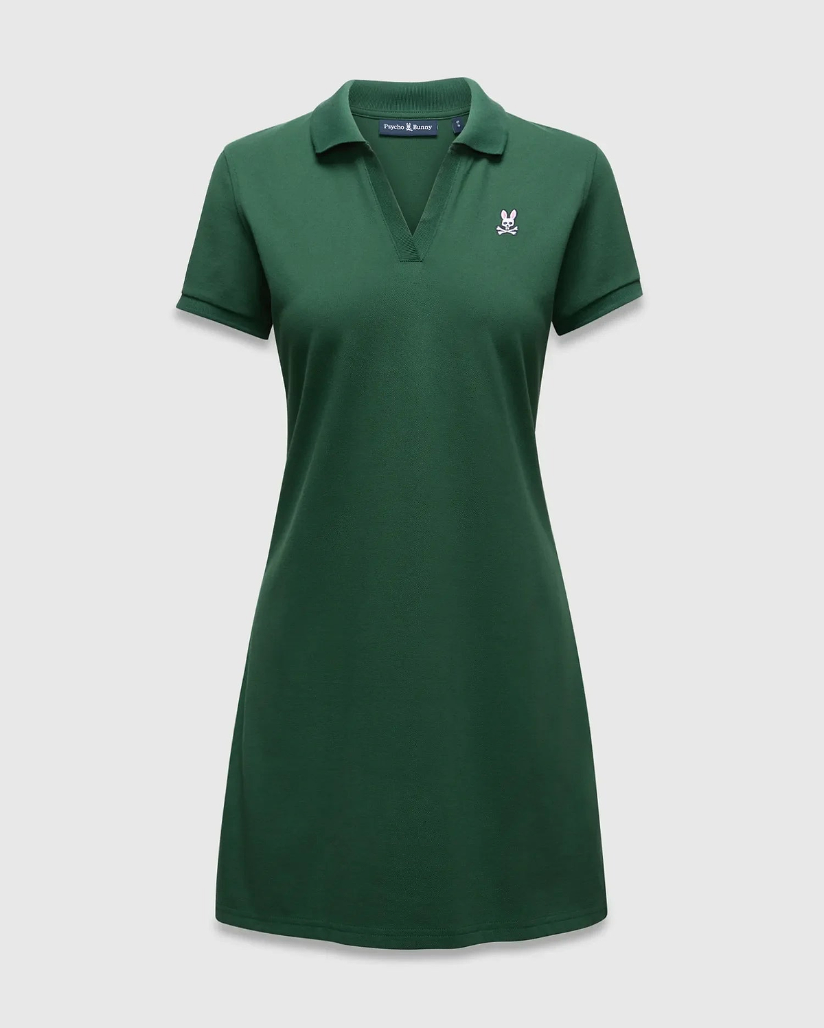 Women's Clara Pique Dress, a dark green polo dress with a classic fit, pique knit texture, and a small embroidered white and pink Psycho Bunny skull logo on the left chest. (5)