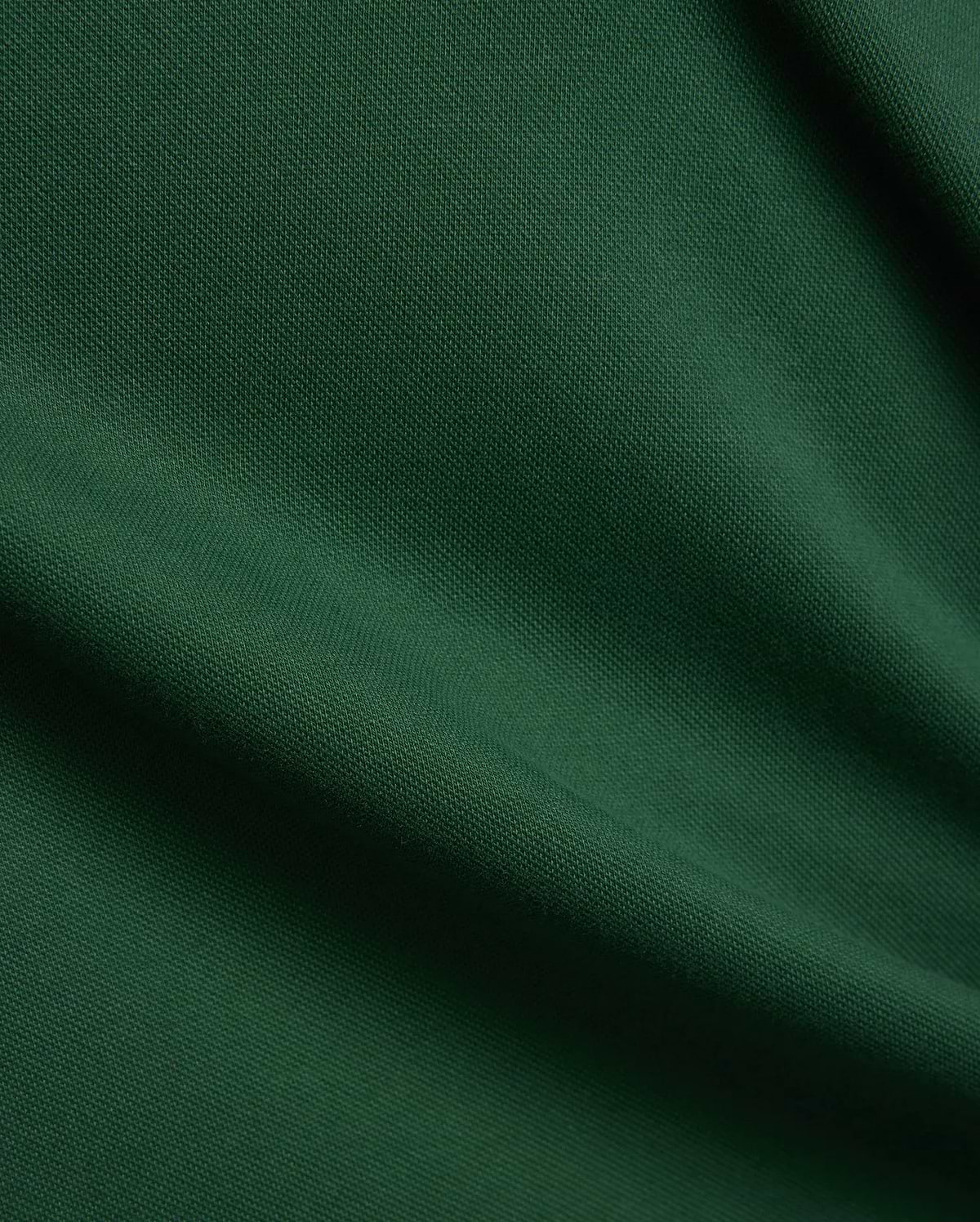 Women's Clara Pique Dress, a luxurious deep forest green garment, featuring a finely woven, breathable pique fabric texture with elegant, soft drapes and subtle shadows, reflecting premium quality. (6)