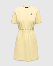 Womens Penelope Dress, a light yellow jersey knit dress with a relaxed fit, crew neck, short sleeves, and an elasticated waist. Features a small pink and white embroidered Psycho Bunny skull logo on the left chest. (4)