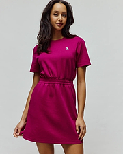 Womens Penelope Dress in vibrant magenta jersey, featuring a relaxed fit, short sleeves, elasticated waist, and a small embroidered white Psycho Bunny skull logo on the left chest. (4)