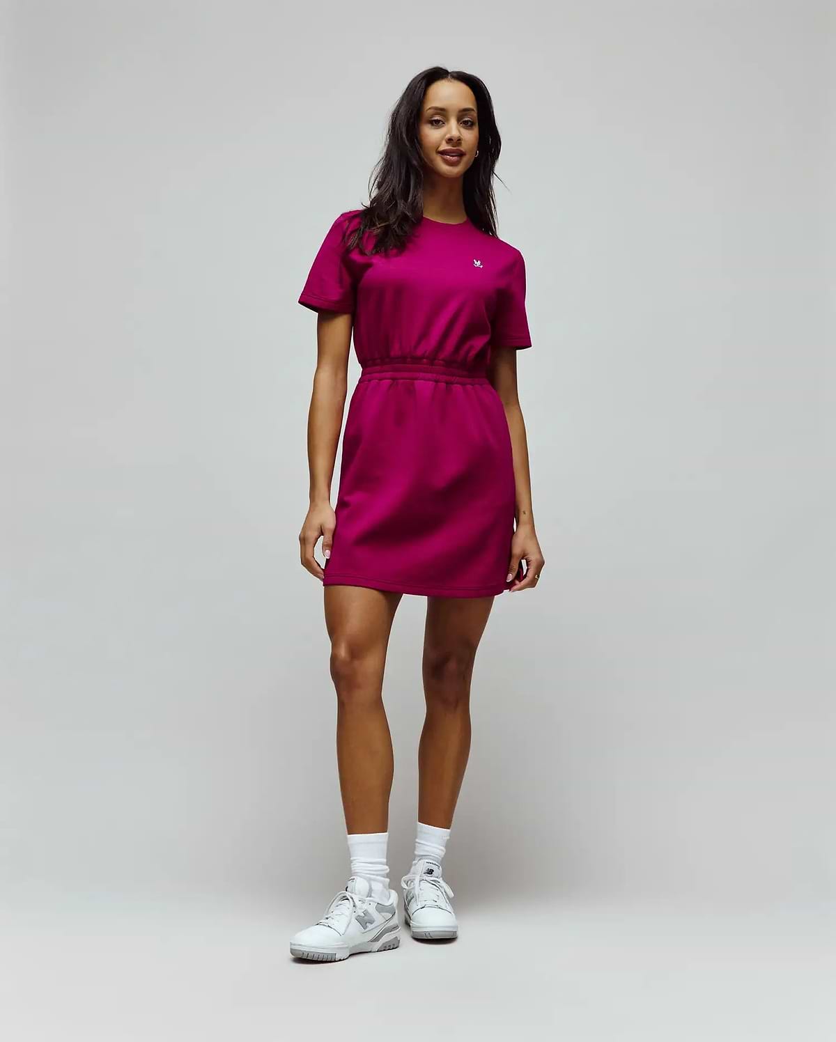 Womens Penelope Dress, a vibrant magenta jersey mini dress with a relaxed fit, crew neck, short sleeves, and an elasticated waist, featuring a small white embroidered Psycho Bunny skull logo on the left chest. (2)