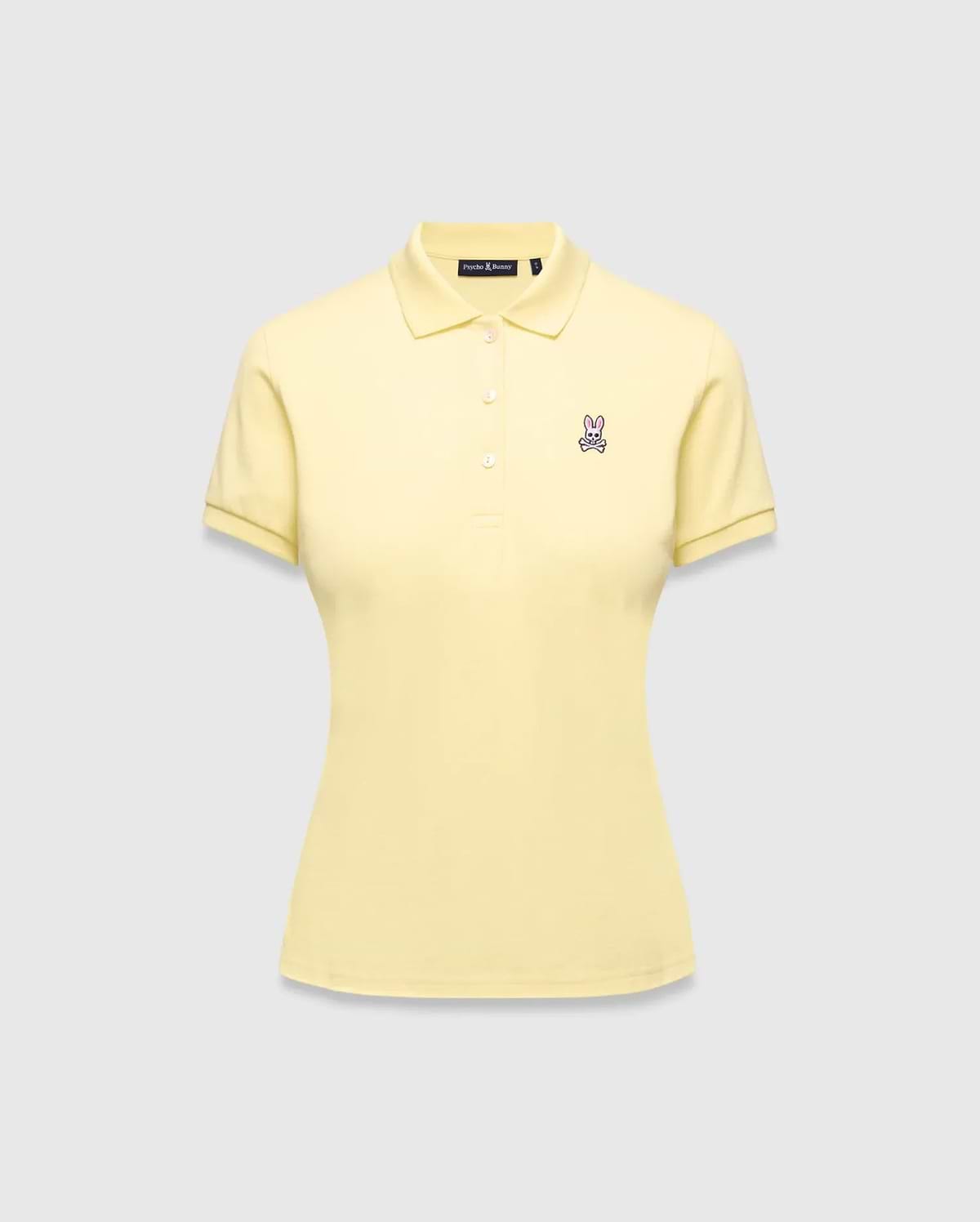 Women's Classic Pique Polo in pale yellow, featuring a classic fit, pique knit fabric, and a small embroidered pink and purple Psycho Bunny skull logo on the left chest.
