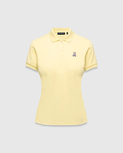 Women's Classic Pique Polo in pale yellow, featuring a classic fit, pique knit fabric, and a small embroidered pink and purple Psycho Bunny skull logo on the left chest.