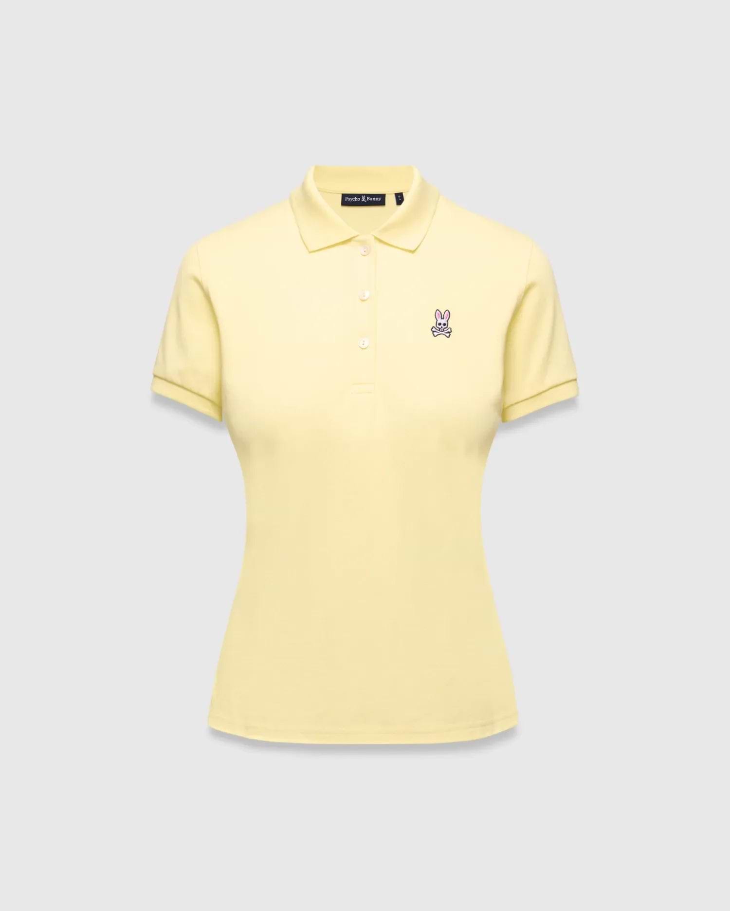 Women's Classic Pique Polo in pale yellow, featuring a classic fit, pique knit fabric, and a small embroidered pink and purple Psycho Bunny skull logo on the left chest.