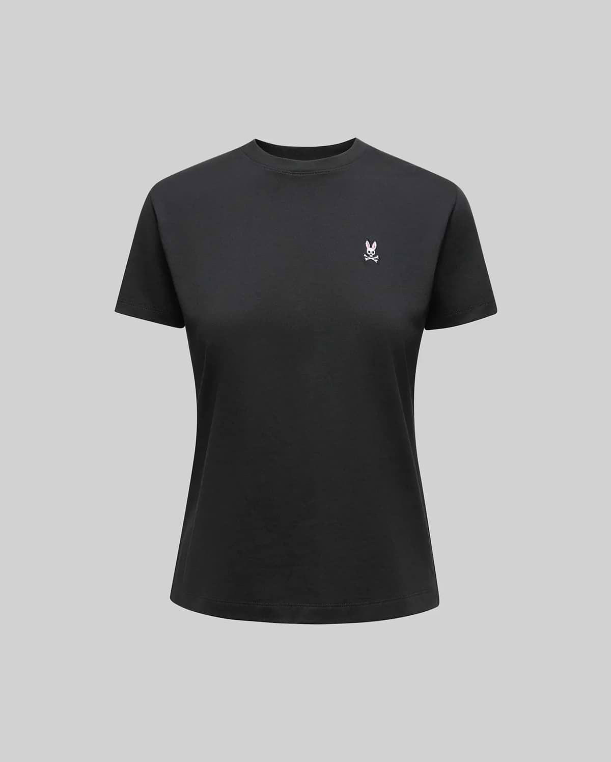 The Psycho Bunny WOMENS CLASSIC TEE - WT0200005 is a plain black Pima cotton shirt with a small white 4k stitch Bunny logo on the left chest, shown on a neutral gray background.
