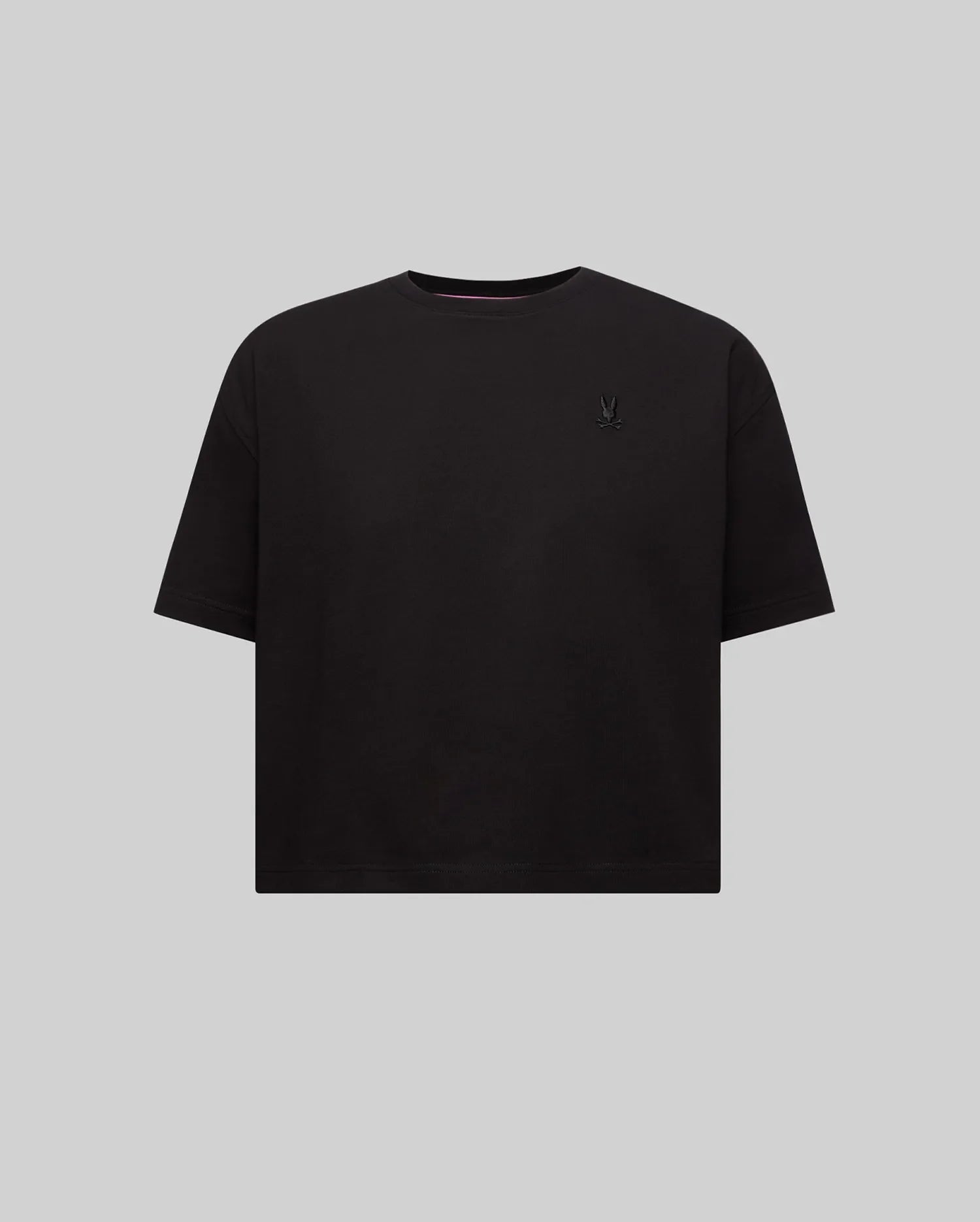 Women's Camille Oversized Fit Tee in black jersey, featuring a small, tone-on-tone embroidered Psycho Bunny skull logo on the left chest and a subtle pink inner collar stripe.