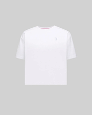 Women's Camille Oversized Fit Tee in white jersey knit, featuring a small embroidered light blue Psycho Bunny skull logo on the left chest and a subtle pink accent trim inside the crew neckline.