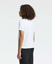 Curly-haired and facing away from the camera, a person wears a Psycho Bunny KIDS CLASSIC PIQUE POLO SHIRT in crisp white, paired with black pants, against a plain white background.