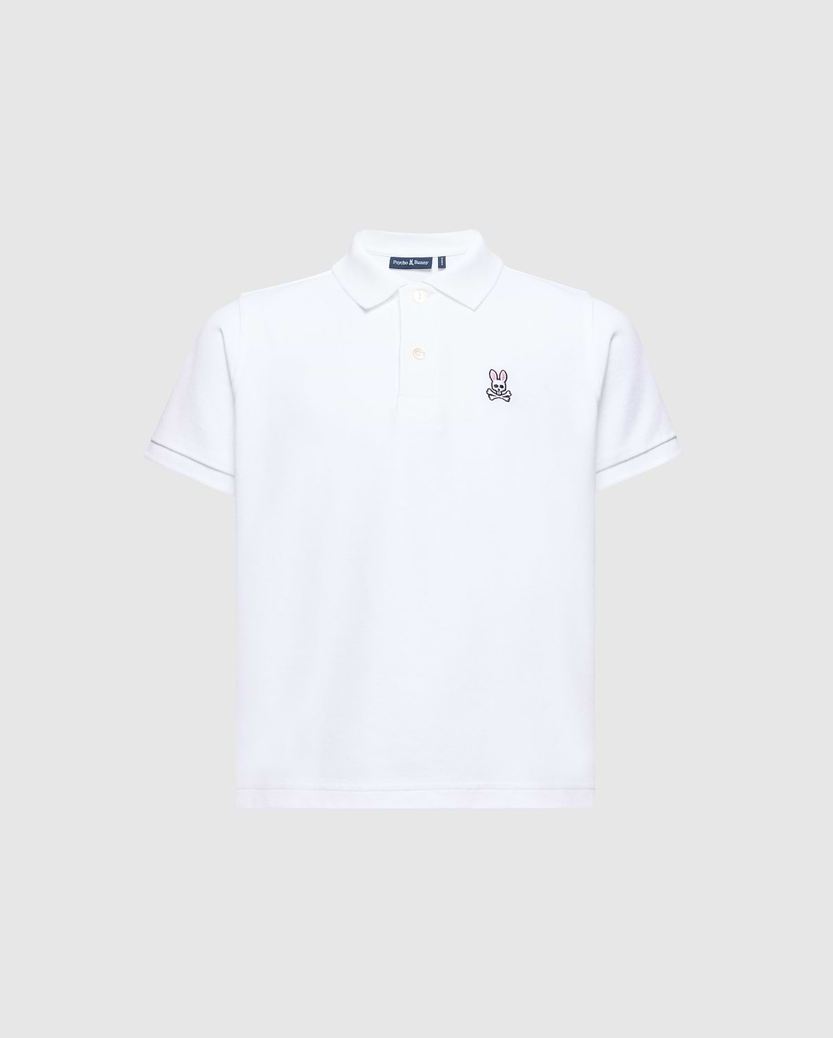 The Psycho Bunny KIDS CLASSIC PIQUE POLO SHIRT - B0K001CRPC is perfect for back-to-school. It features short sleeves, a collar, and an embroidered bunny logo on the left chest against a plain light gray background.